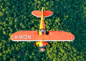 UPF-7 Waco Biplane over Trees